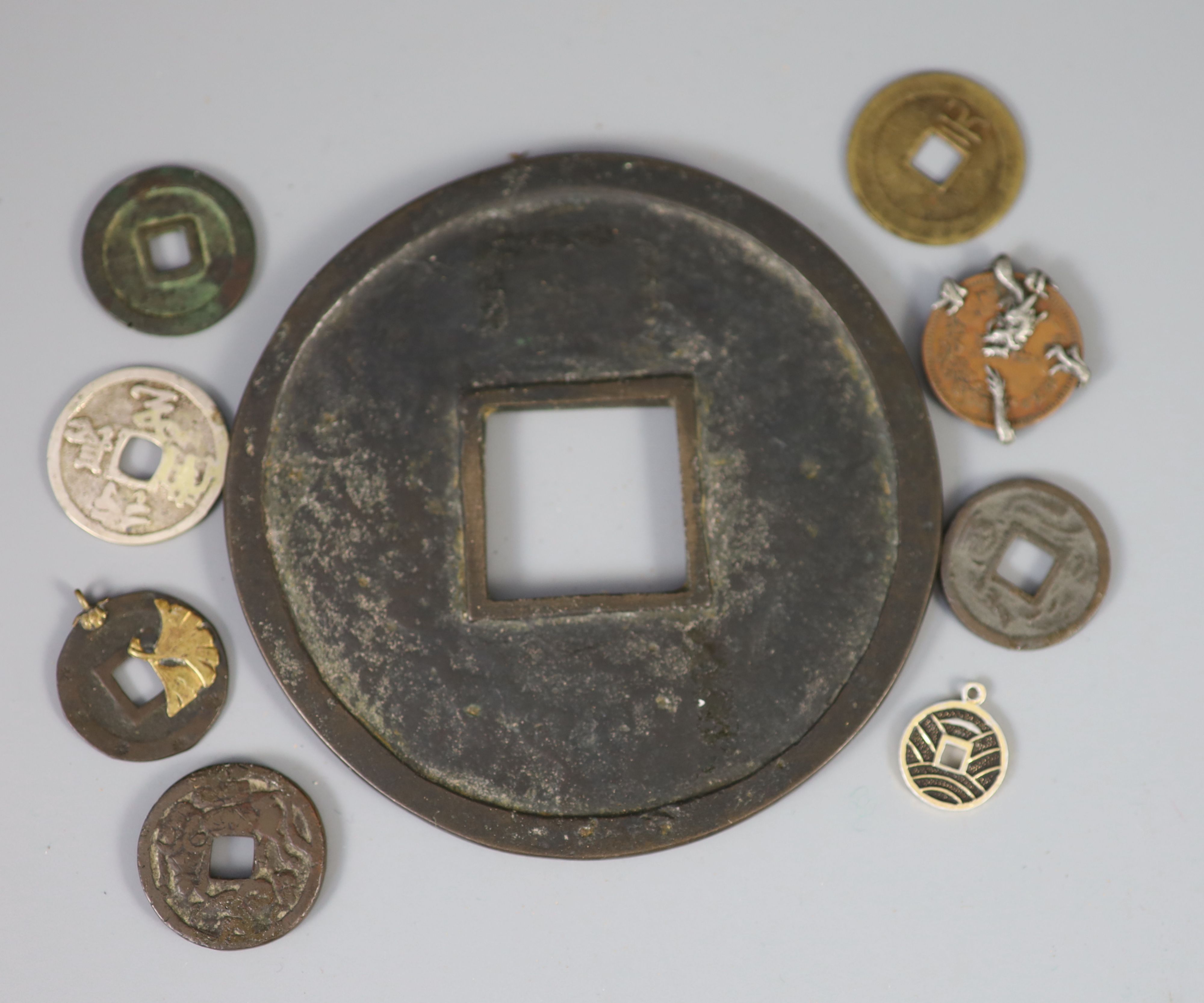 A group of Japanese bronze coin charms or amulets, 19th/20th century,